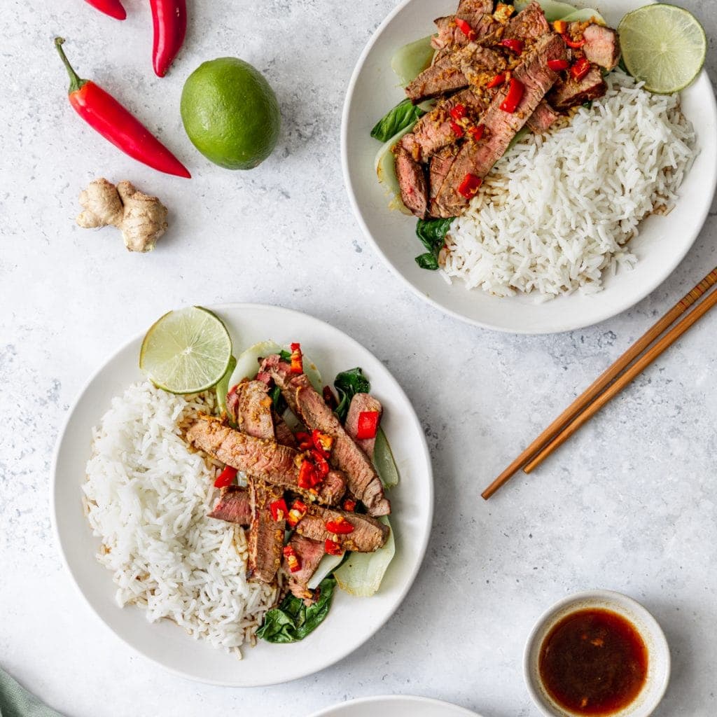 two plates of Asian beef with pak choi
