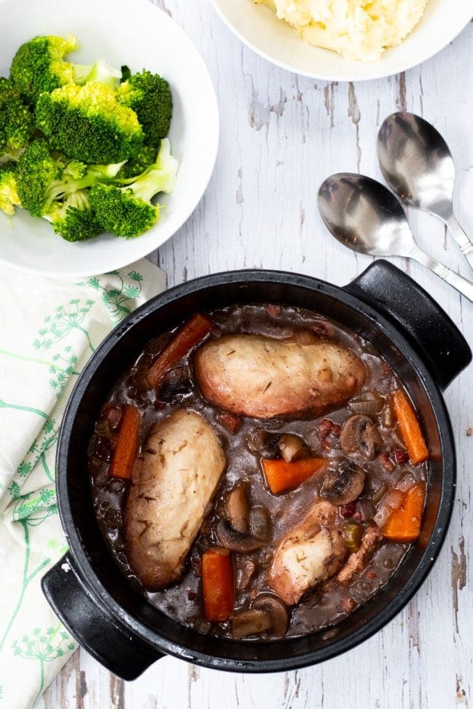 easy coq au vin in a saucepan with broccoli and mashed potato