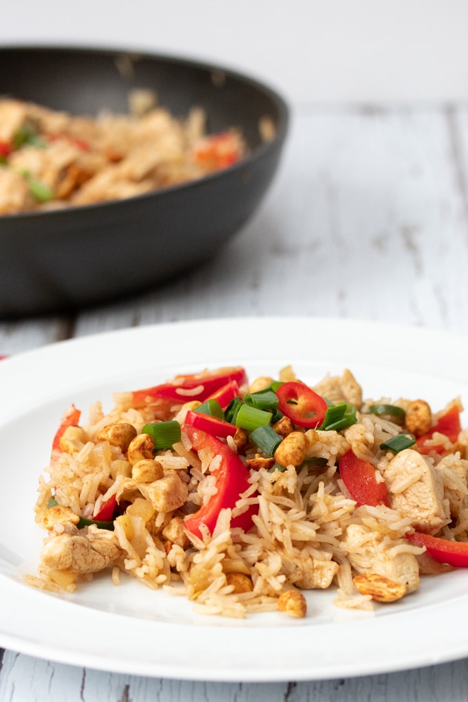 plate of chicken fried rice with pan in the background