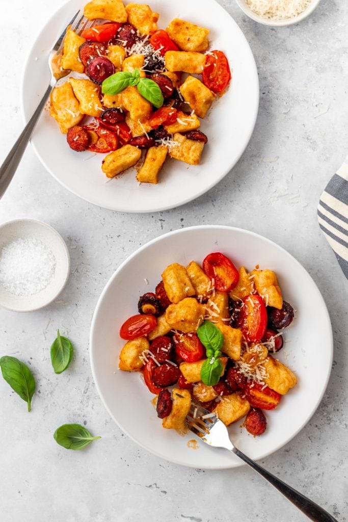 two plates of garlic chorizo gnocchi