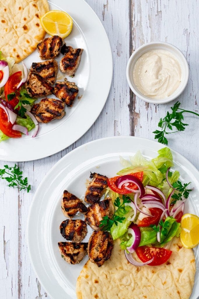 two plates of yogurt marinated chicken