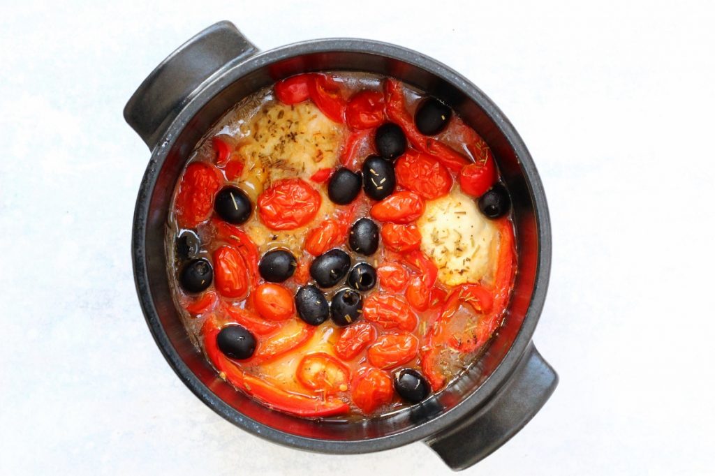 Pot of baked Italian chicken with olives, tomatoes, peppers