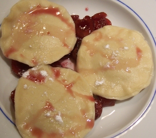 Chocolate ravioli with cherry sauce