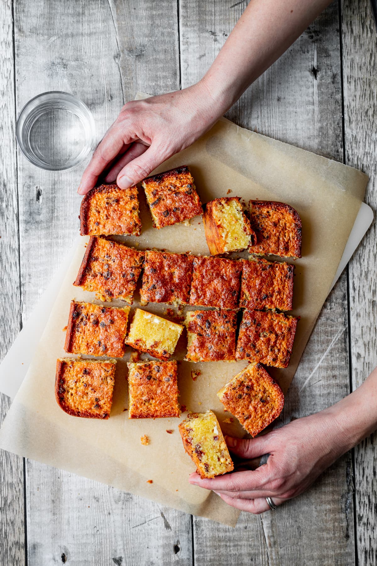 hands holding freeze dried raspberry blondies