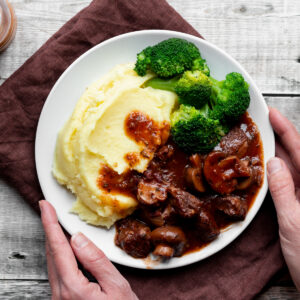 Classic beef bourguignon with mashed potato and broccoli
