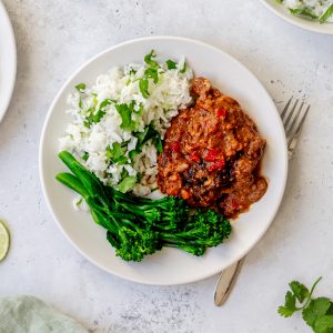 plate of slow cooker peanut pork with rice and broccoli