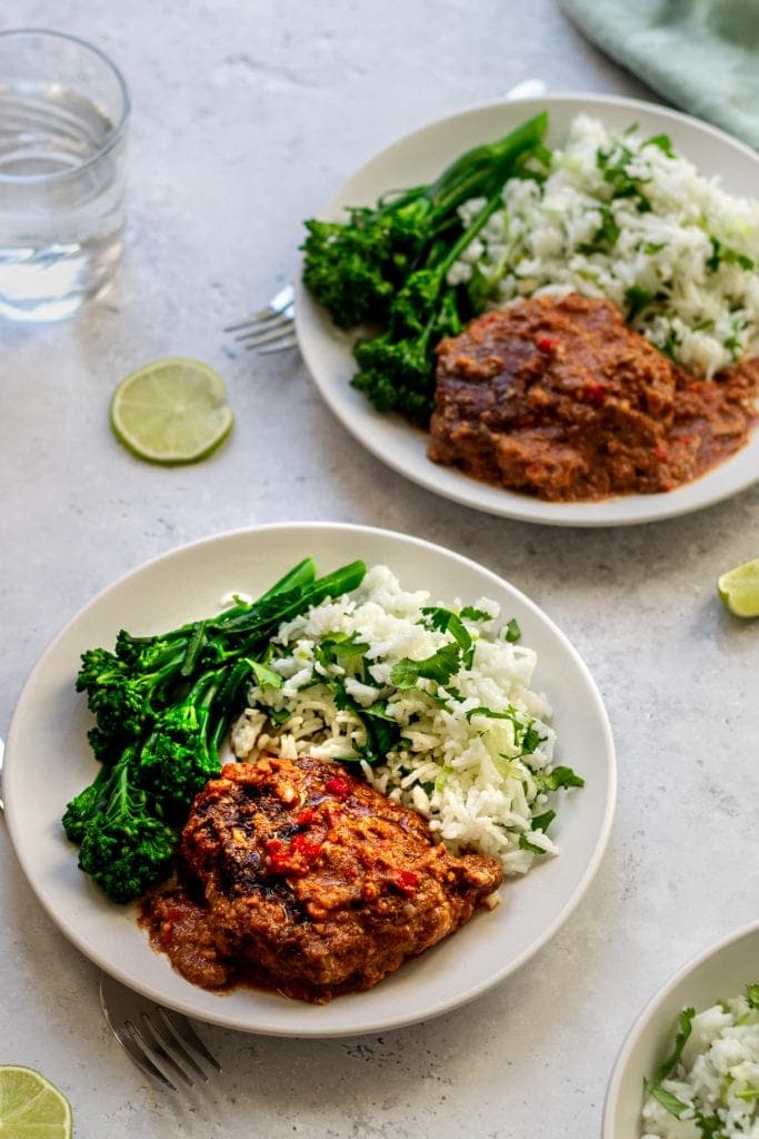 two plates of slow cooker pork with peanut sauce