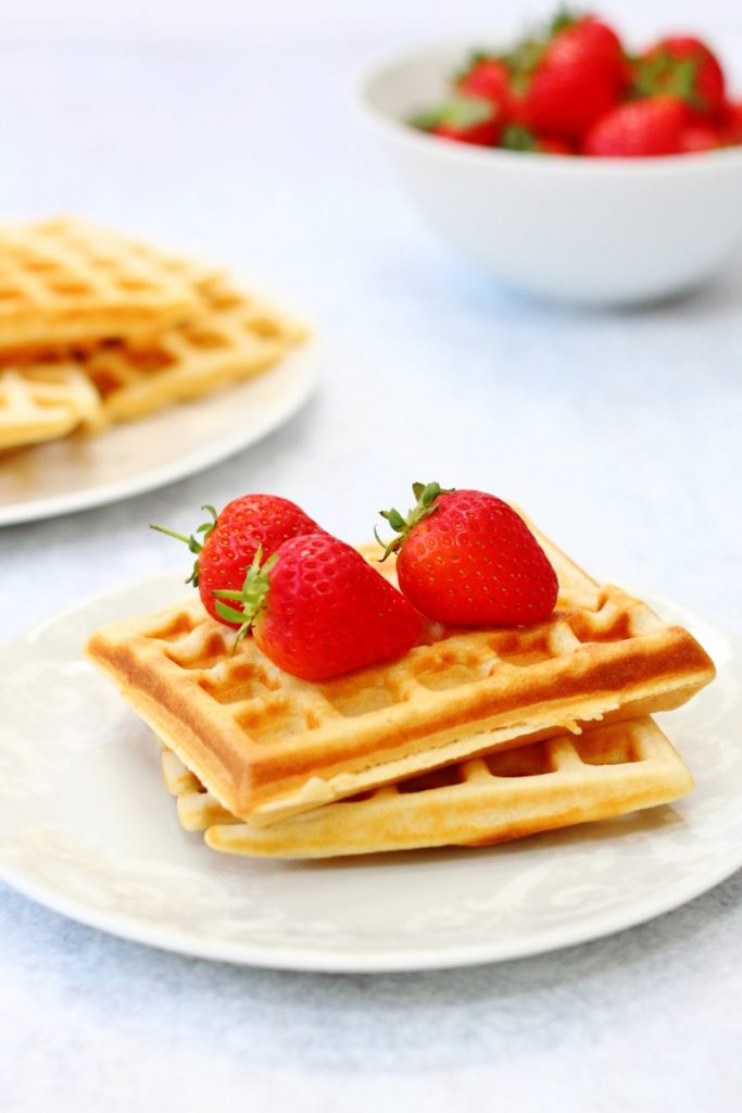 Homemade waffles on a plate with strawberries