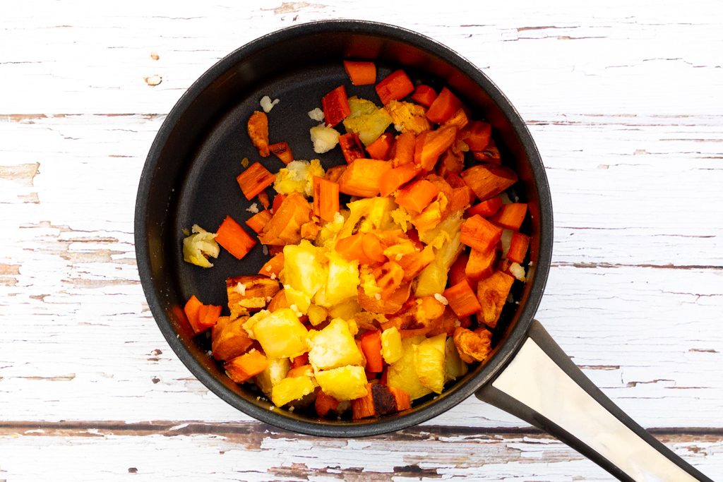 Diced roasted vegetables in a saucepan