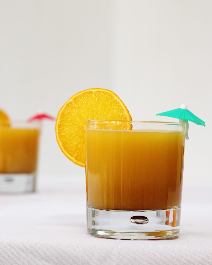 Orange and pomegranate molasses mocktail in a glass