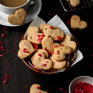 Dish of heart shaped strawberry flavoured shortbread biscuits