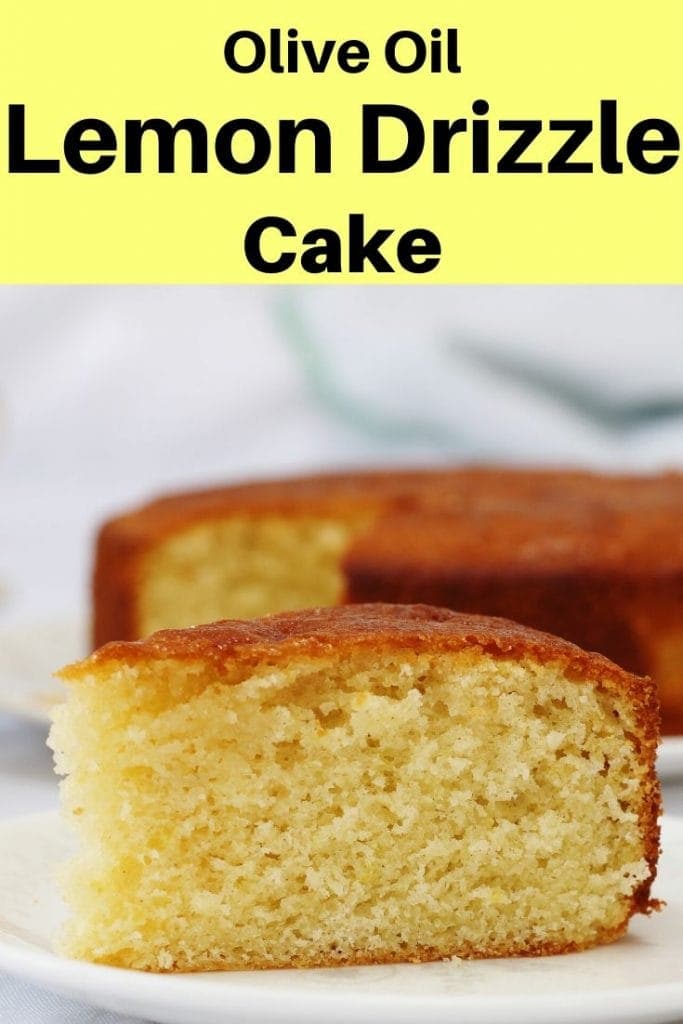 slice of olive oil lemon drizzle cake with cake in background