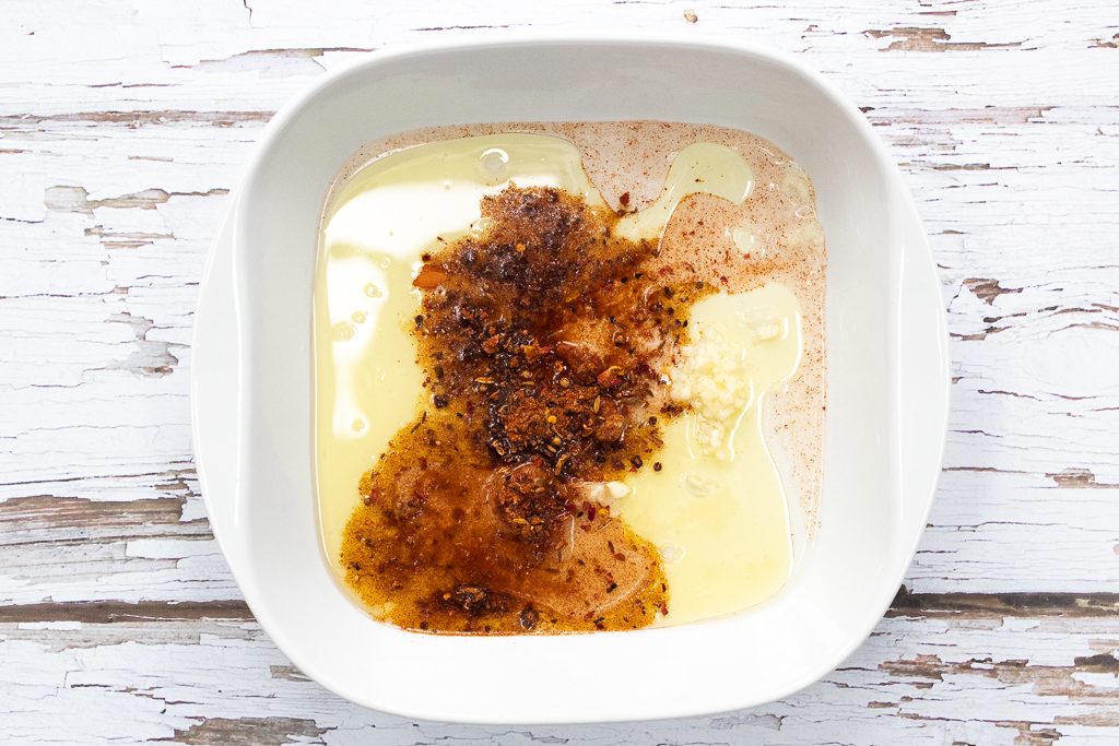 marinade including crushed garlic, white wine vinegar, olive oil and ras el hanout