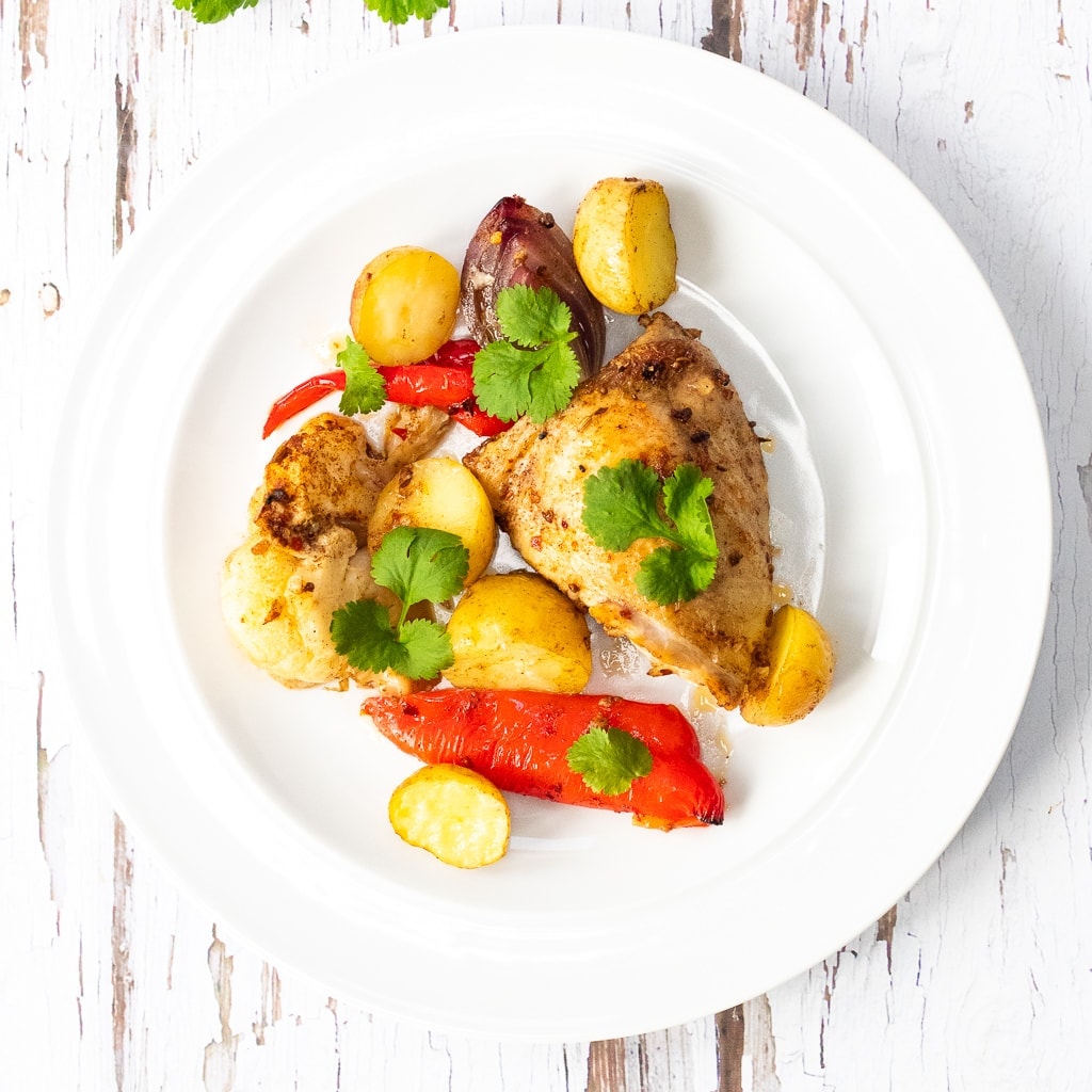 plate of ras el hanout chicken tray bake