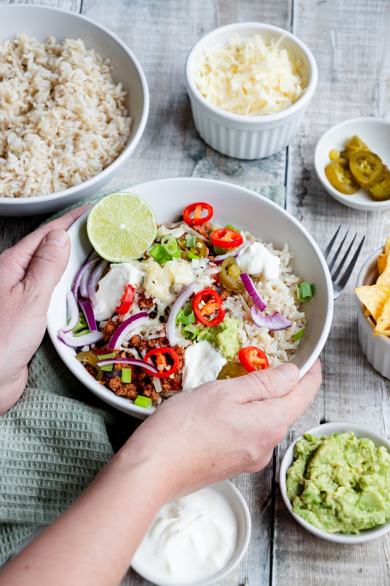 Bowl of chilli con carne with lots of toppings