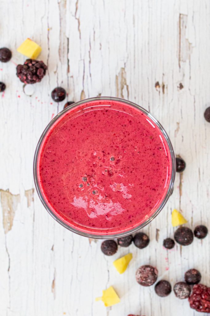 red berry smoothie in a glass from above