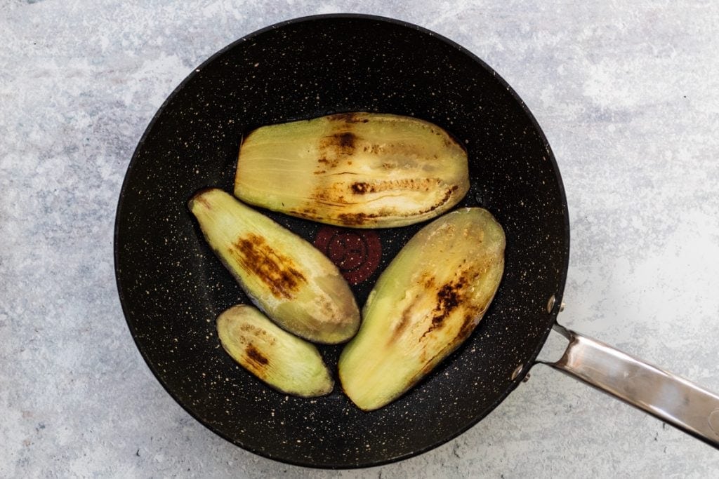 Aubergine slices in a frying pan