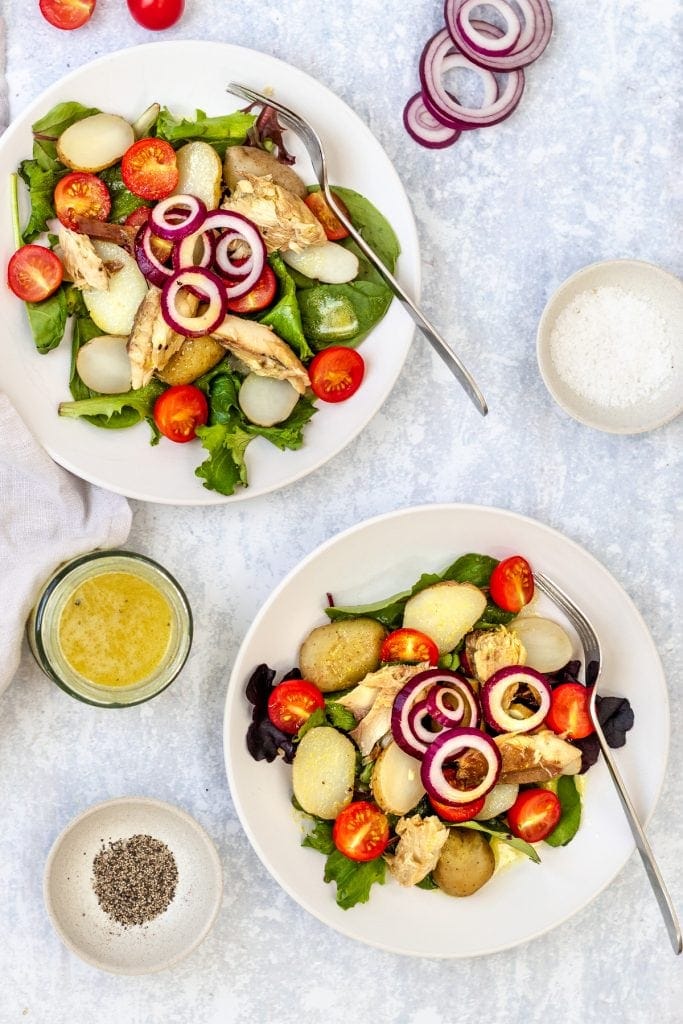 flatlay with two plates of potato and mackerel salad