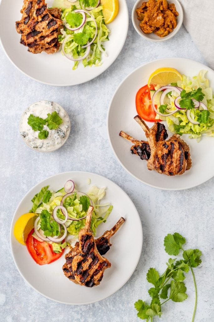 flatlay of 3 plates of Indian lamb chops