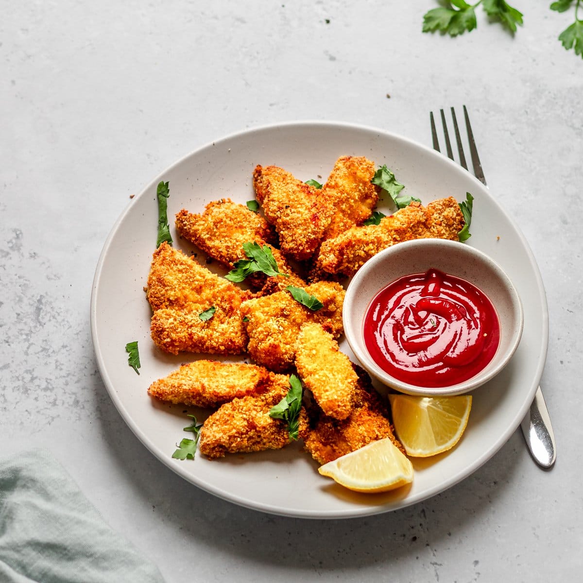 plate of spicy air fryer chicken nuggets and ketchup
