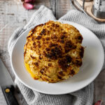whole air fried cauliflower on a plate