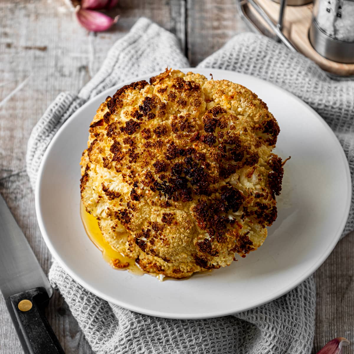 whole air fried cauliflower on a plate