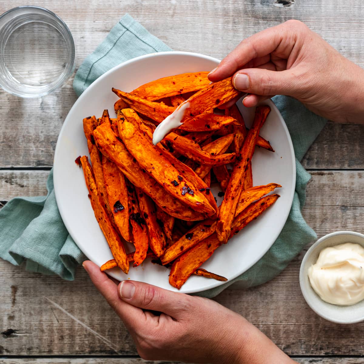 Hand holding sweet potato wedge