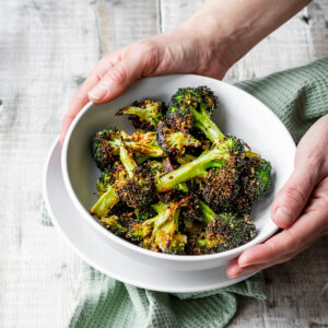 bowl of air fried broccoli with parmesan