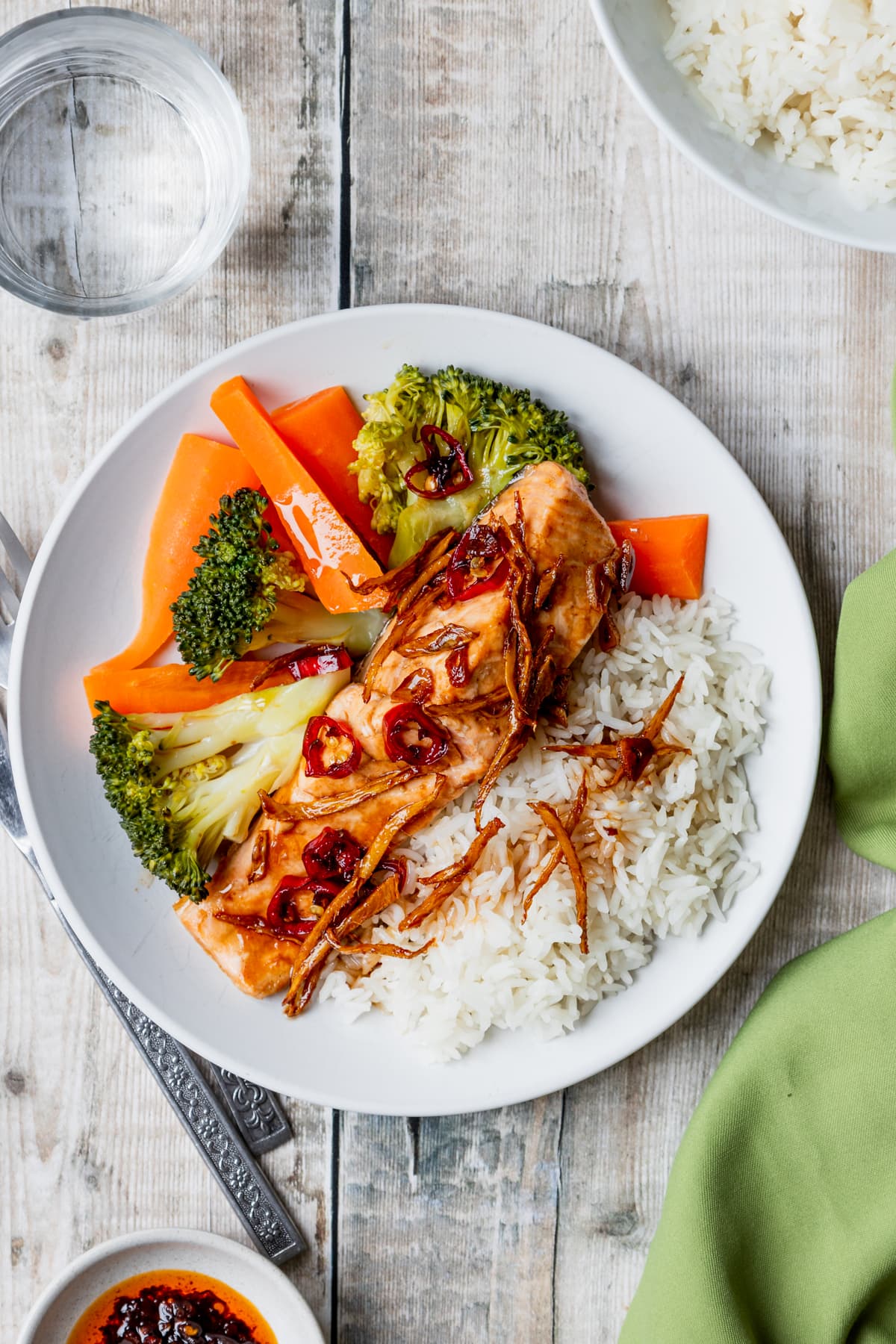 plate of steamed salmon and rice with a ginger garlic chilli sauce
