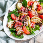 Plate of air fried fennel salad with salad leaves and grapefruit