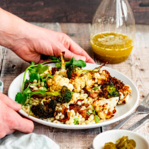 Salad with a glass bottle of jalapeno lime vinaigrette