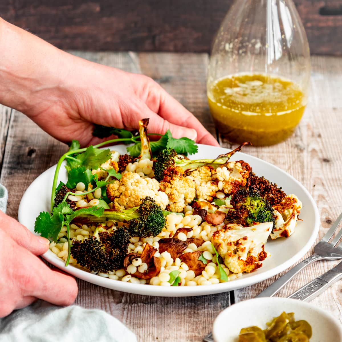 Salad with a glass bottle of jalapeno lime vinaigrette