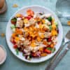 Mexican inspired salad topped with crushed Doritos