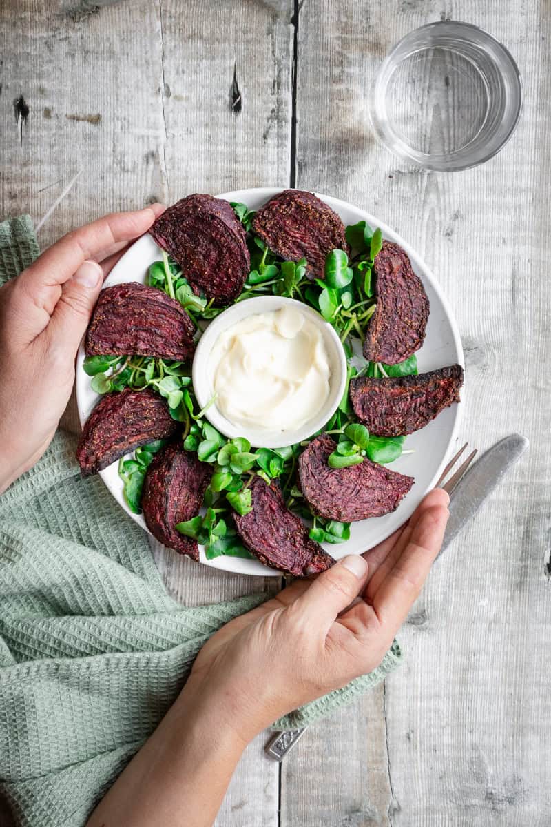 Plate of air fried beetroot wedges with watercress and mayonnaise