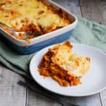Plate of doritos lasagne with dish of lasagne in the background