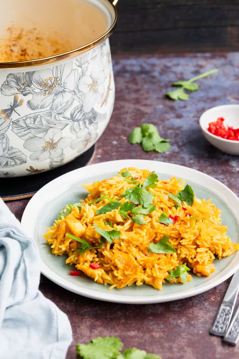 spicy Mexican rice with pot in the background